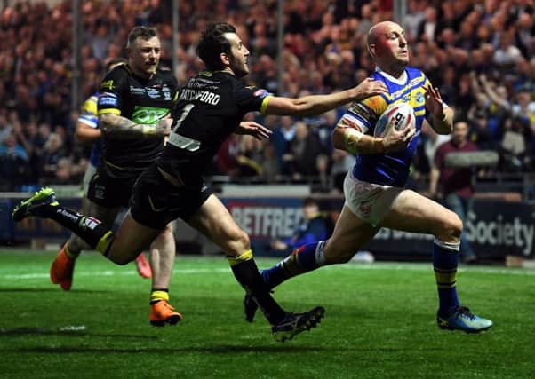 Rhinos' Carl Ablett gets away from Wolves' Stefan Ratchford to score. Picture Jonathan Gawthorpe