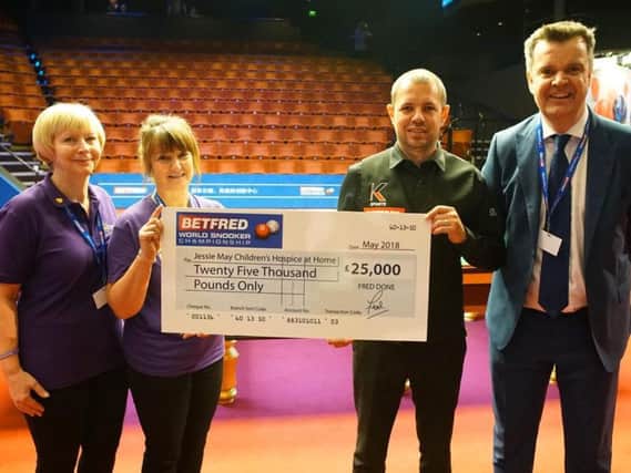 Barry Hawkins hands over the 25,000 cheque.
