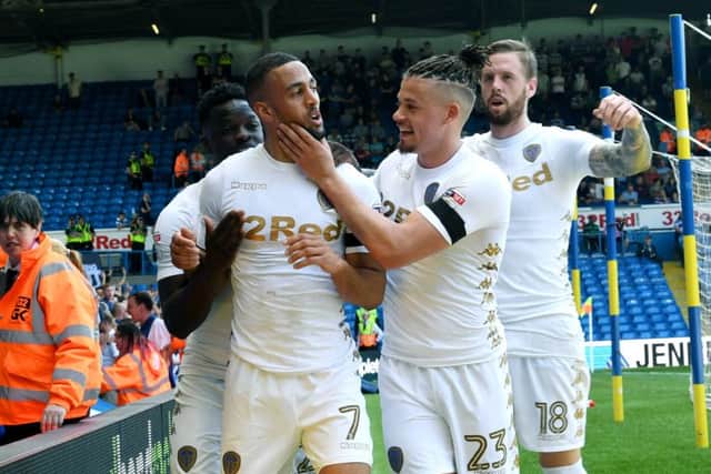 TOP MAN: Kemar Roofe is congratulated by his Leeds team-mates after opening the scoring.
 Picture Jonathan Gawthorpe.