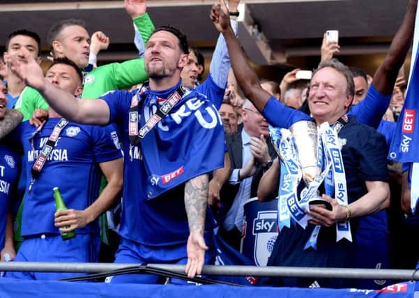 Cardiff City manager Neil Warnock celebrates with his players after clinching promotion to the Premier League (Picture: Simon Galloway/PA Wire).
