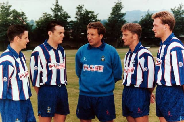 Then 

Huddersfield Town manager Neil Warnock greets his new signings at the Second Division club's photo call in July 1994, l-r, Paul Reid, Robbie Ryan, Tom Cowan and Kevin Gray.