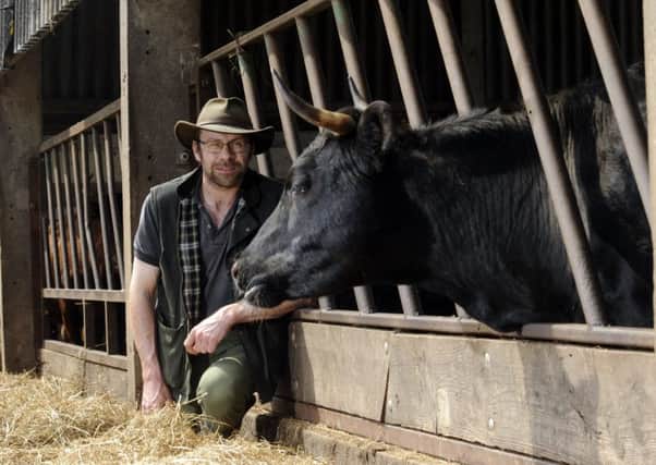 Robert Rose pictured with cattle at Rosewood Farm, Ellerton. Picture by Simon Hulme.