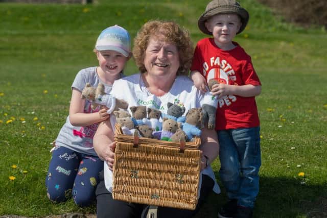 Former midwife Rosie Bullard, with two children Anna, 7, and Ellis, Chandler, of Leeds, and a selection of knitted toys for children who have hurt themselves. Picture James Hardisty