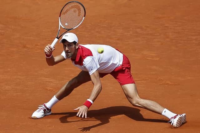Novak Djokovic returns the ball to Kyle Edmund during the Madrid Open. Picture: AP/Paul White