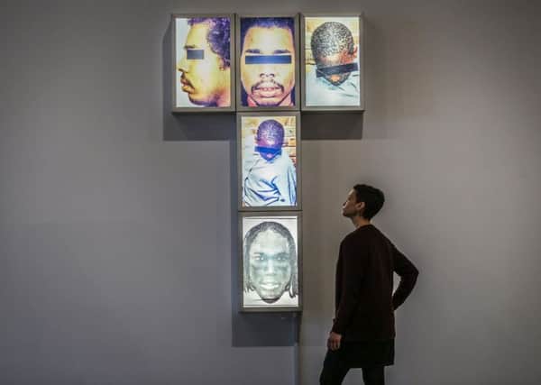 PUBLIC IMAGE: Kerry Chase from the Yorkshire Sculpture Park with Self-Portrait Black Men Public Enemy by Donald Rodney. PIC: PA