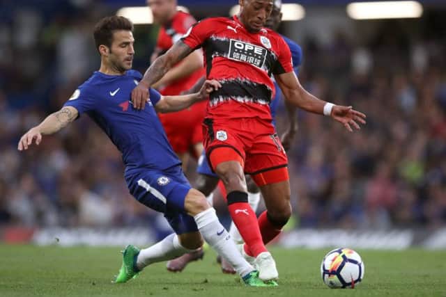 Chelsea's Cesc Fabregas (left) and Huddersfield Town's Rajiv van La Parra battle for the ball at Stamford Bridge. Picture: John Walton/PA