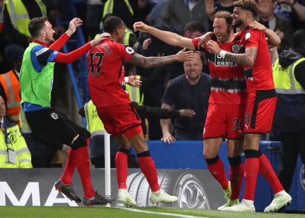 Huddersfield Town's draw at Chelsea secured their Premier League status.