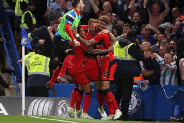 Huddersfield Town's Laurent Depoitre (centre) celebrates scoring his side's goal against Chelsea at Stamford Bridge. Picture: John Walton/PA
