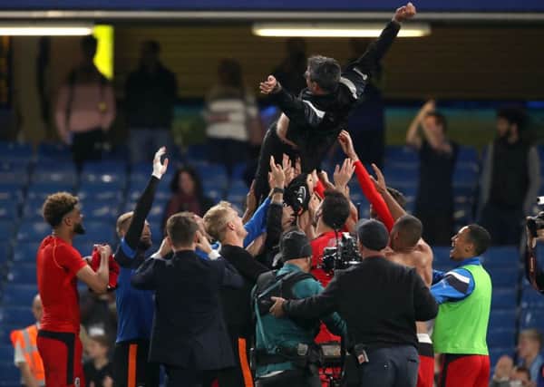 Huddersfield Town players lift manager David Wagner in the air as they celebrate. Picture: John Walton/PA