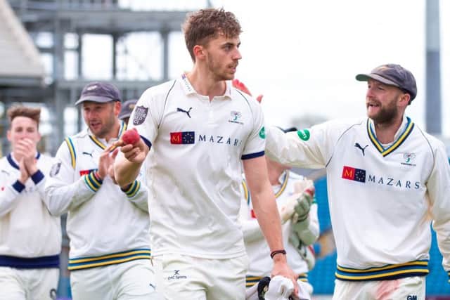 Yorkshire's Ben Coad leads the team off the field after taking 10 wickets in the match on the way to beating Notts.