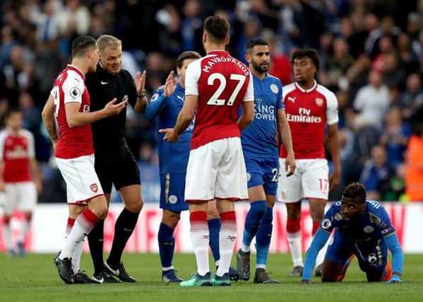 Off: Arsenal's Konstantinos Mavropanos (27) is sent off by referee Graham Scott at Leicester.