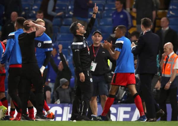 Huddersfield Town manager David Wagner (centre) celebrates after his side secured their Premier League status for another season at Stamford Bridge on Wednesday night. Picture: John Walton/PA