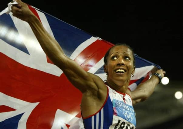 Dame Kelly Holmes celebrates after winning the Women's 800m