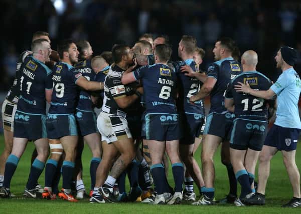 Featherstone Rovers and Hull FC's players confront each other.