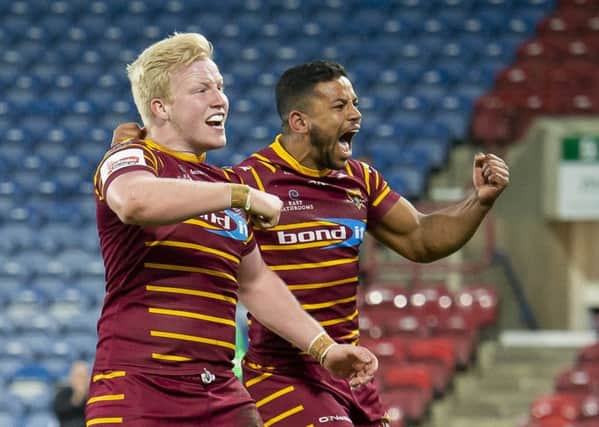Huddersfield's Matty English celebrates his try against Wakefield with Kruise Leeming.