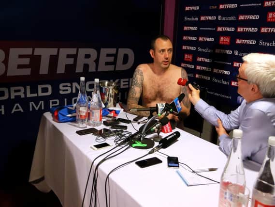 NAKED TRUTH: Mark Williams - as promised - attends his post-match press conference (almost) naked. Picture: PA.
