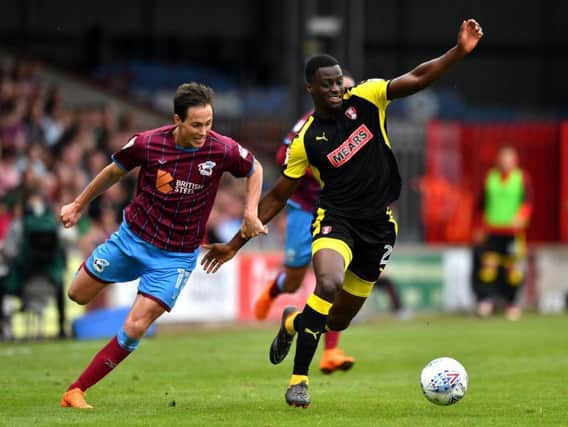 Rotherham United's Josh Emmanuel (right) and Scunthorpe United's Josh Morris battle for the ball at Glanford Park. Picture: Anthony Devlin/PA