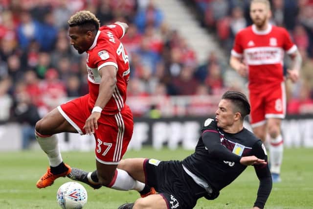 Middlesbrough's Adama Traore (left) and Aston Villa's Jack Grealish battle for the ball at the Riverside Stadium. Picture: Owen Humphreys/PA