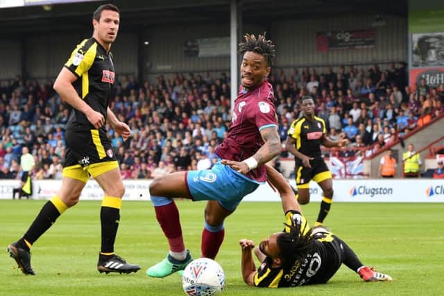 Scunthorpe United's Ivan Toney (centre) and Rotherham United's Michael Ihiekwe battle for the ball at Glanford Park. Picture: Anthony Devlin/PA