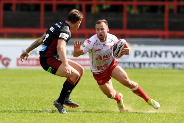 Wigan's Sam Powell prepares to stop Hull KR's Adam Quinlan at KCOM Craven Park. Picture: James Hardisty.