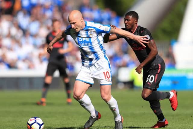 Huddersfield Town's Aaron Mooy (left) and Arsenal's Ainsley Maitland-Niles battle for the ball at the John Smith's Stadium. Picture: Mike Egerton/PA