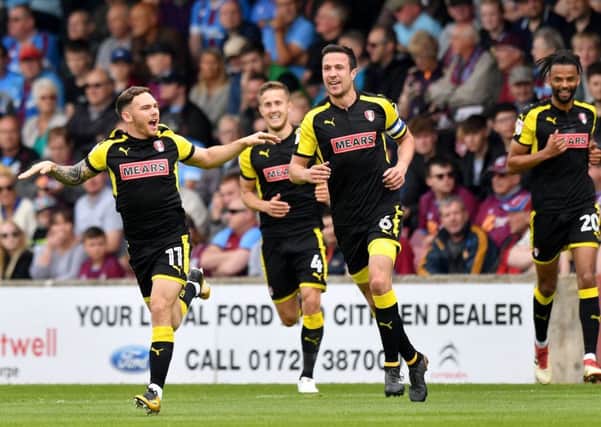 Rotherham United's Jon Taylor, left, celebrates scoring his side's first goal of the game in the  League One play-off semi-final first leg at Scunthorpe (Picture: Anthony Devlin/PA Wire).
