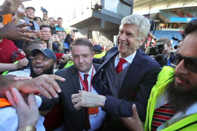 Arsene Wenger, after his 1,235th and last match as Arsenal manager, smiles as the visiting fans at Huddersfield Town bade him farewell following their single-goal victory (Picture: Mike Egerton/PA Wire).