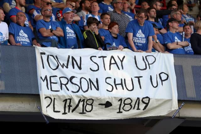 A banner answers one of Huddersfield Towns doomsayers, pundit and former Arsenal player Paul Merson (Picture: Mike Egerton/PA Wire).