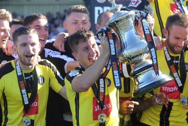 Harrogate Town captain Josh Falkingham with the National League North play-off trophy (Picture: Tony Johnson).