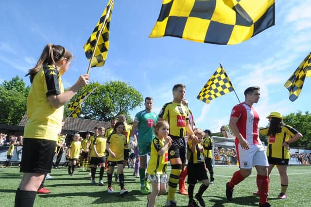 Harrogate Town and Brackley players enter the field (Picture: Tony Johnson).
