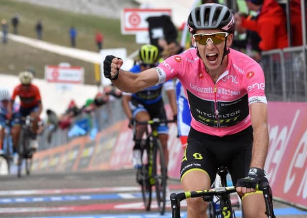 Britain's Simon Yates celebrates as he crosses the finish line to win the 9th stage of the Giro de Italia cycling race.