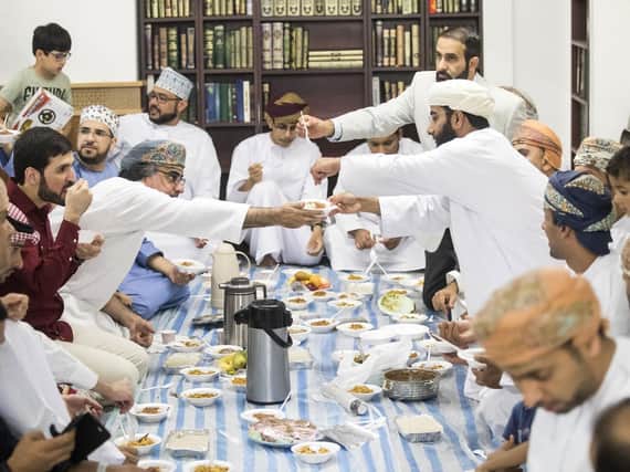 Worshipers share food following the Eid prayer, which marks the end of Ramadan and the start of Eid, at Leeds Grand Mosque. Credit: PA.