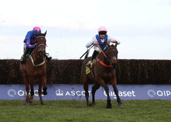 Waiting Patiently and Brian Hughes (right) lead Cue Card and Paddy Brennan away from the last fence before going on to win the Ascot Chase.