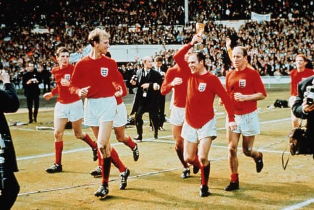 Finest hour:  Ray Wilson holds the Jules Rimet Trophy as he  performs a lap of honour with the Charlton brothers at Wembley after England won the World Cup against West Germany 4-2. Picture: Getty Images