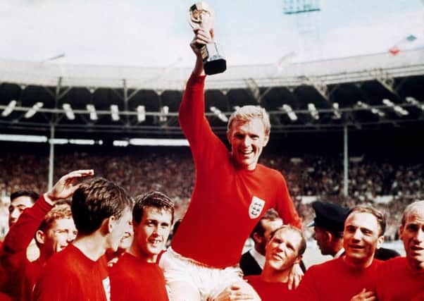 World Cup winners: England captain Bobby Moore, carried shoulder high by Geoff Hurst, left, and Ray Wilson. Picture: AP