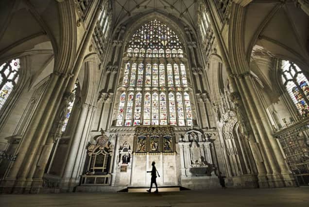 Lead Labourer Andy Bracegirdle walks past the 600-year old Great East Window in York Minster, as work is completed in a decade-long project to conserve and restore the largest expanse of medieval stained glass in the country.