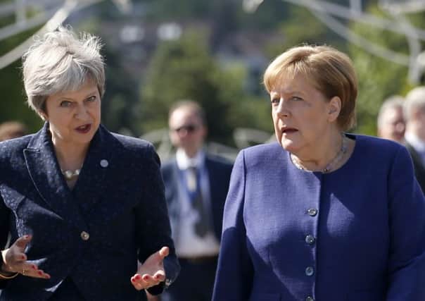 Theresa May and Angela Merkel at yesterday's gathering of EU leaders.