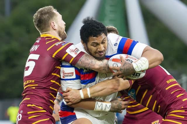 Wakefield's Pauli Pauli fights through the tackles of Huddersfield's Paul Clough and Lee Gaskell. Picture: Allan McKenzie/SWpix.com.
