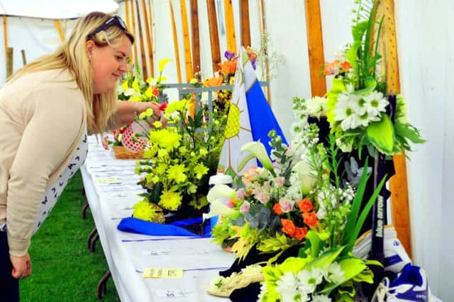 Charlotte Lister from Steeton keeping hers and two generations of her family's flower arrangements watered ready for judging.