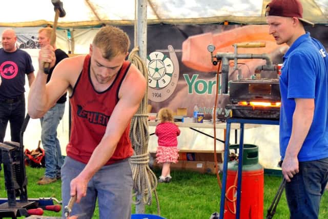 Oli May (left) and Jake Harland from Harrogate taking part in the horseshoe making competition.
