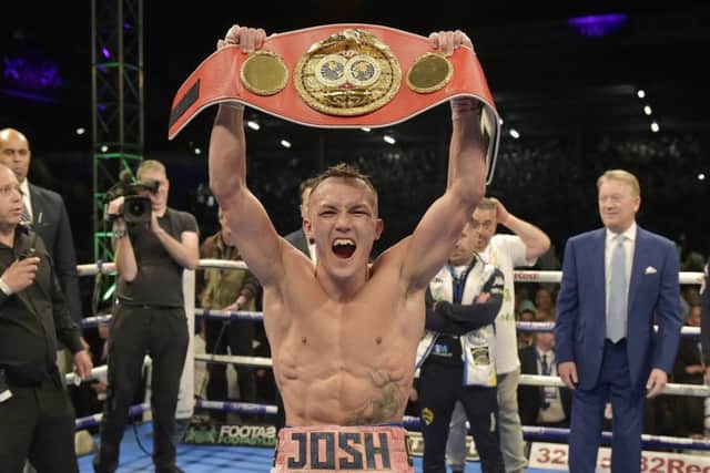 TOP OF THE WORLD: Leeds boxer Josh Warrington celebrates as he lifts the world title belt after his points victory over Lee Selby at Elland Road. Picture: Steve Riding