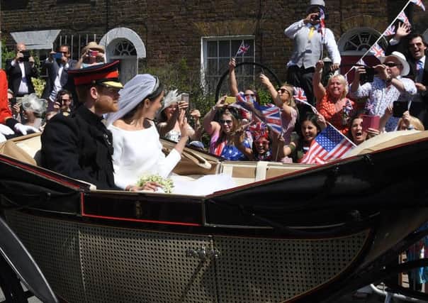 The Duke and Duchess of Sussex ride through Windsor after their wedding, a photo captured by The Yorkshire Post's Simon Hulme for the Press Association.