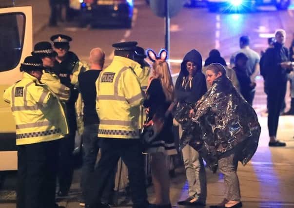 The emergency services helping people near Manchester Arena following the terrorist attack in May last year. (PA).