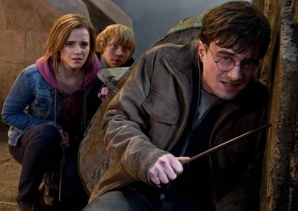In this film publicity image released by Warner Bros. Pictures, from left, Emma Watson, Rupert Grint and Daniel Radcliffe are shown in a scene from "Harry Potter and the Deathly Hallows: Part 2."   (AP Photo/Warner Bros. Pictures, Jaap Buitendijk)