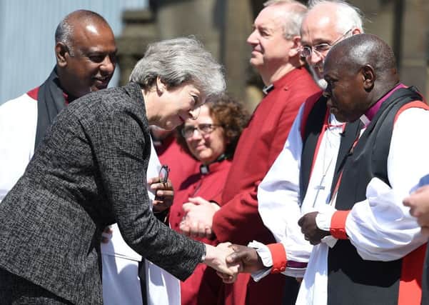 Archbishop of York Dr John Sentamu (right) greets Prime Minister Theresa May as she arrives for the Manchester Arena National Service of Commemoration at Manchester Cathedral to mark one year since the attack on Manchester Arena.