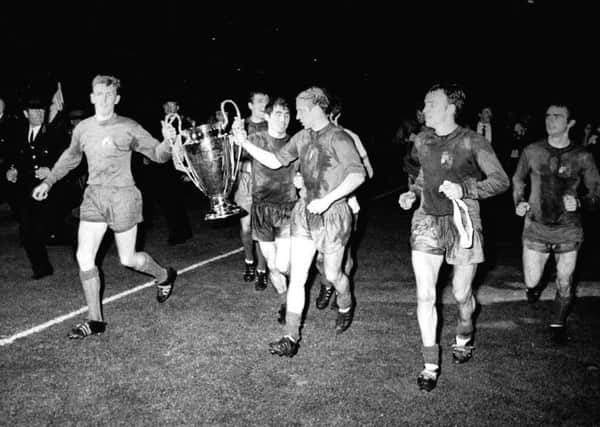 Manchester Uniteds captain Bobby Charlton holds the European Cup along with goalkeeper Alex Stepney after they defeated Portugals champions Benfica at Wembley on May 29,1968 to become the first English winners of the competition (Picture: PA/PA Wire).