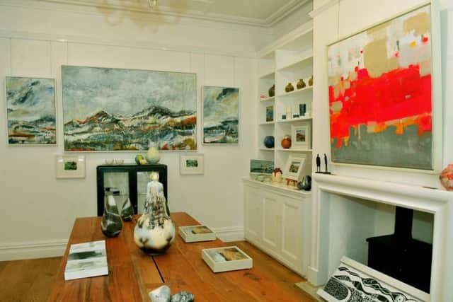 The gallery in the front room with a collection of ceramics, including the largest in the centre by Emma Spence, raku by Eric Moss and glass by Julia Rashworth. The painting above the jewellery cabinet is by Sally Marie Gardner. The painting above the fireplace is by Angeline Tournier