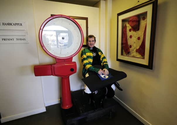 Twenty times jump jockey Sir AP McCoy on the old weighing room scales at Catterick racecourse.
