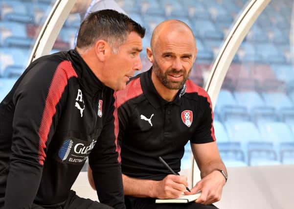 Rotherham United manager Paul Warne (right) and assistant manager Richie Barker in the dugout at Glanford Park. Picture: Anthony Devlin/PA