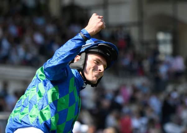 FRENCH TRIUMPH: James Reveley punches the air in triumph after winning the Grand Steeple-Chase de Paris at the Hippodrome dAuteuil. Picture: LIionel Bonaventure/AFP/Getty Images